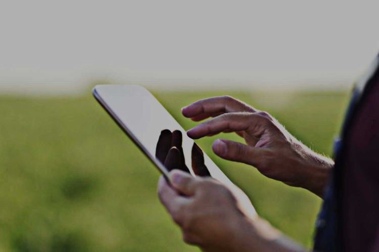 close up of a person holding a tablet